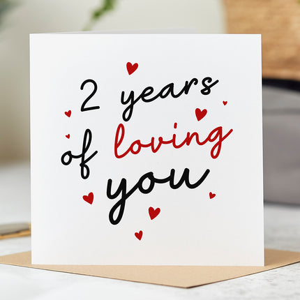 Anniversary card that reads '2 Years Of Loving You' surrounded by red hearts.