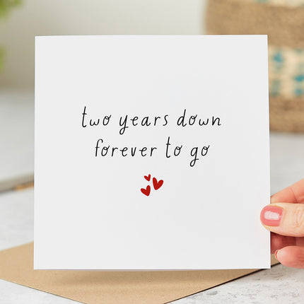 Anniversary card that reads 'two years down forever to go' followed by three red hearts.