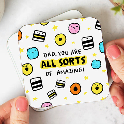 White coaster with playful liquorice allsorts illustrations and reads 'Dad, You Are All Sorts Of Amazing'.