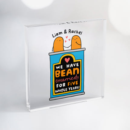 Personalised acrylic block featuring an illustration of a tin of beans with two beans holding hands, celebrating five years of marriage and personalised with two names.