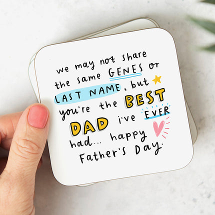 White coaster with that reads 'We may not share the same genes or last name but you're the BEST DAD I've ever had... Happy Father's Day'.'