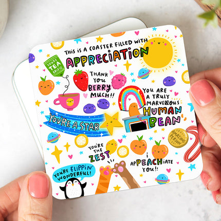 White coaster that reads 'This Is A Coaster Filled With Appreciation' surrounded by colourful and playful thank you puns.