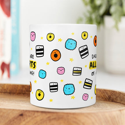 Middle view of a white ceramic mug with playful liquorice allsorts illustrations.