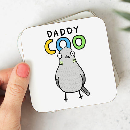 White coaster with a cartoon pigeon illustration and the text 'Daddy Coo'.