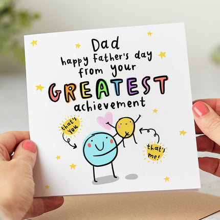Image of a funny Father's Day card with the message 'Dad Happy Father's Day from Your Greatest Achievement' surrounded by a colourful illustration.