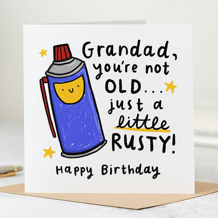 Greeting card that reads 'Grandad, You're Not Old... Just A Little Rusty! Happy Birthday' in playful fonts and with an illustration of an oil can.