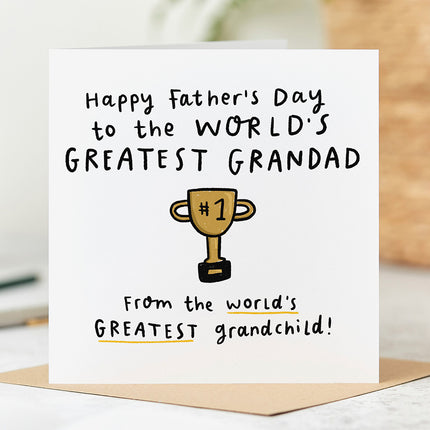 Fathers Day card that reads 'Happy Father's Day To The World's Greatest Grandad From The World's Greatest Grandchild' with a playful trophy cup illustration.