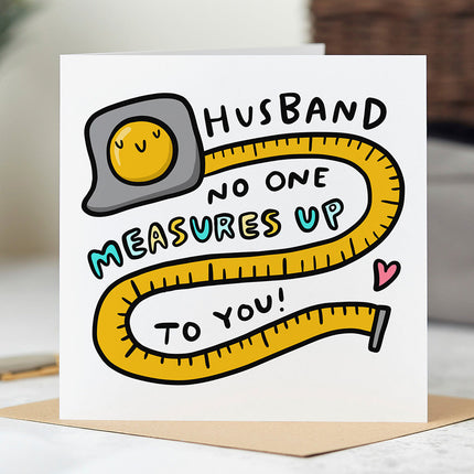 Greeting card that reads 'Husband No One Measures Up To You!' with a silly tape measure illustration.
