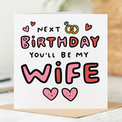 Fiancée Birthday card that reads 'Next Birthday You'll Be My Wife' with hearts and wedding ring illustrations.