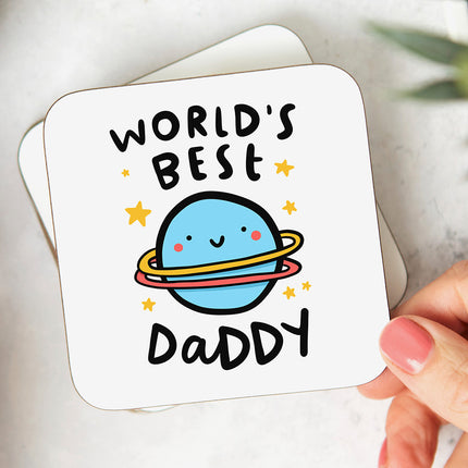 White coaster with a playful planet illustration and the text 'World's Best Daddy'.