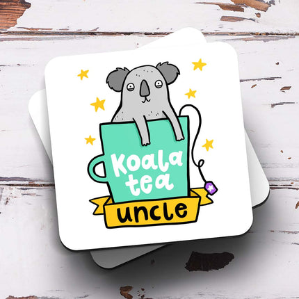 A white coaster with an illustration of a koala in a teacup surrounded by stars. The text reads 'Koala Tea Uncle'.